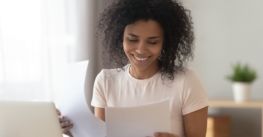 woman smiling looking at AC bill