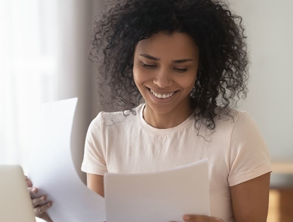 woman smiling looking at AC bill
